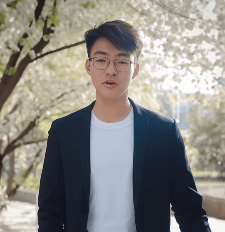 图片展示的是HeyGen内置数字人形象，为一位戴眼镜的年轻男性，身着黑色西装外套搭配白色T恤，背景是户外场景，有树木和花朵。该图片与文档中“HeyGen内置数字人可以有手势”的内容相关，用于说明HeyGen已内置多种虚拟形象，可选择自己喜欢的形象进行视频制作，为后续视频剪辑和发布做准备。