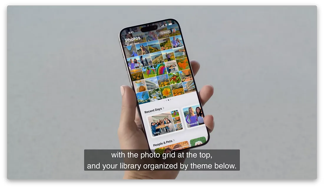 图片展示了一只手握着iPhone，屏幕上显示照片应用界面。上方是照片网格，呈现多张不同场景的照片缩略图。下方有“Recent Days”和“People & Pets”两个分类，分别展示了最近几天和人物与宠物的照片。图片下方文字说明“with the photo grid at the top, and your library organized by theme below.”，与上下文介绍照片应用重新设计，基于主题、人物和旅行的收藏显示在照片网格下方的内容相呼应。
